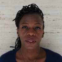 A photo of Garvia against a stone backdrop, looking directly at the camera.